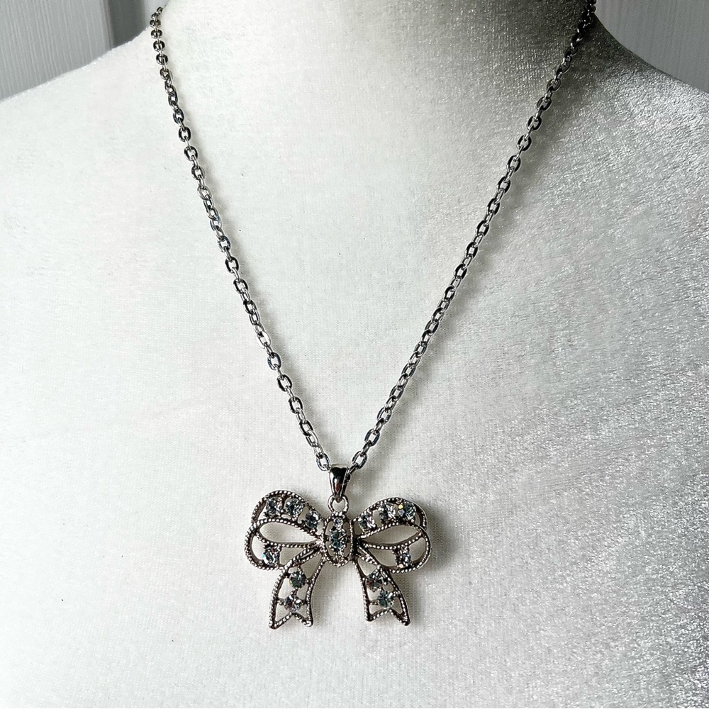 Silver tone rhinestone studded sparkle bow pendant necklace on silver tone chain